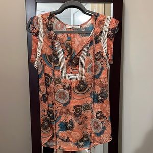 This is a boutique top. Sleeveless with pretty details.